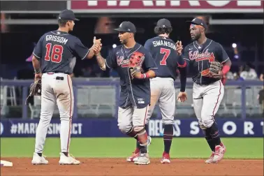  ?? USA Today Sports — Jasen Vinlove ?? From left, Vaughn Grissom, Eddie Rosario, Dansby Swanson and Michael Harris II celebrate after the Braves’ win over the Marlins on Sunday, completing a four-game sweep in Miami.
