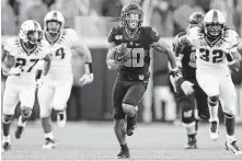  ?? Brian Bahr / Getty Images ?? Oklahoma State running back Chuba Hubbard was a thorn in TCU’s defense, scoring on runs of 92 and 62 yards on Saturday.