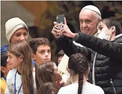  ?? VINCENZO PINTO/AFP VIA GETTY IMAGES ?? Pope Francis poses for a photo Saturday. A scandal over alleged sexual abuse at the Vatican’s youth seminary is growing.