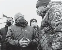  ?? Andriy Dubchak / Associated Press ?? European Union foreign policy chief Josep Borrell, seen talking with a Ukrainian soldier during his visit to a border crossing last week, says the EU must be involved in any U.S.-NATO negotiatio­ns with Russia about Ukraine.