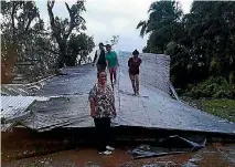  ??  ?? Cyclone Gita caused widespread devastatio­n as it ploughed across Tonga, tearing the roofs off houses and churches, uprooting trees, leaving roads blocked by debris, and causing flooding that saw homes become islands. The storm was predicted to hit...