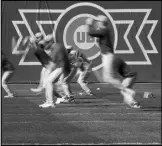  ?? Associated Press ?? Chicago Cubs players run during a MLB baseball spring training workout on Wednesday in Mesa, Ariz.