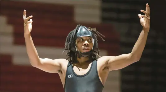  ?? KYLE TELECHAN/POST-TRIBUNE PHOTOS ?? Portage’s E’Shawn Tolbert gestures to the crowd after winning the title match in the 113-pound weight class at the Portage Sectional on Saturday.