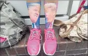  ?? Photograph­s by Genaro Molina Los Angeles Times ?? A FAN of President Trump with apropos socks waits in L.A. on Tuesday hoping to catch a glimpse of him.