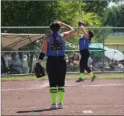  ?? Alex Eller ?? Spirit White’s Brianna Arguello makes a acrobatic catch on the third base line against the Polk County Slammers as Mya Weverka looks on.