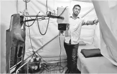 ??  ?? A man shows an X-ray equipment to be used at the Malaysian field hospital in Bangladesh. — Bernama photo