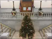  ?? BY CARL HESSLER JR. — MEDIANEWS GROUP ?? A Christmas tree, decorated with white lights and red and white poinsettia and situated at the top of the grand staircase, provided the perfect backdrop for the chorus.