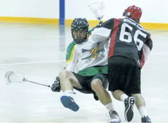  ?? CLIFFORD SKARSTEDT/ EXAMINER ?? Ennismore James Gang's Nick Andreoli (8) is levelled by Six Nations Rivermen's Marcus Elvin (66) during Game 2 action of the OLA senior B semifinal on Saturday at the Robert E.Young Recreation Complex in Ennismore.James Gang lost 10-3.