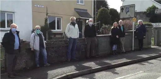  ??  ?? ●
Cllr Bryan Owen and Peter Rogers with residents of Church Street, Newborough