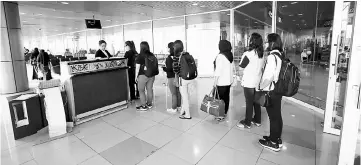  ??  ?? Passengers queue in the room used to hold internatio­nal passengers when there are internatio­nal flights at KIA. The doors will be closed when there are internatio­nal flights and passengers will not have access to the domestic lounge or toilets on Level...