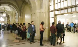  ?? ANTONIO PEREZ/CHICAGO TRIBUNE ?? Chicagoans line up at City Hall to purchase city stickers for their autos on July 15, 2014, the last day to purchase the stickers without risking a ticket.