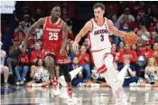  ?? RICK SCUTERI / AP ?? Arizona guard Pelle Larsson (3) drives past Wisconsin guard John Blackwell (25) during the first half of a game in Tucson, Ariz., on Dec. 9. No. 1-ranked Arizona faces No. 3 Purdue on Saturday in Indianapol­is.