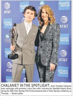  ??  ?? Actor Timothee Chalamet poses backstage with presenter Laura Dern after receiving the Spotlight Award, Actor, during the 30th Palm Springs Film Festival Awards Gala in Palm Springs, California, on Thursday. — Reuters photo