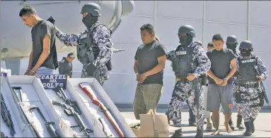  ?? ?? GANGBUSTER­S: Members of the Gulf Cartel are taken into custody in a 2010 roundup.The crime outfit has engaged in brutal turf wars in the area where four Americans were abducted last week.