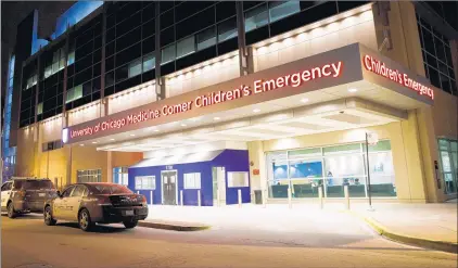  ?? ARMANDO L. SANCHEZ/CHICAGO TRIBUNE ?? Police vehicles sit outside Comer Children’s Hospital, where an 11-year-old was taken Jan. 31 after being shot in the 10300 block of South Avenue N in Chicago.