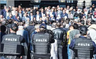  ?? ILYAS AKENGIN/AFP ?? Parliament members of Pro-Kurdish Peoples’ Democratic Party (HDP) and protesters gather as Turkish antiriot police officers stand guard yesterday during demostrati­on in Diyarbakir.