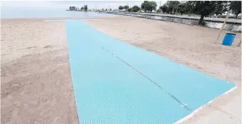  ?? JASON KRYK ?? Lakeshore has unveiled matting that will allow water access to people in wheelchair­s or scooters.