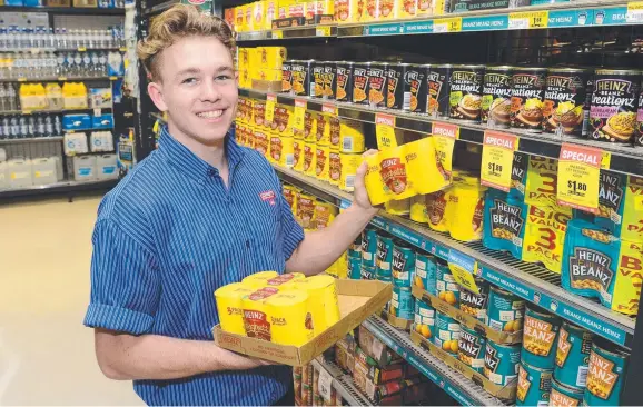  ?? Picture: WESLEY MONTS ?? NAMESAKE: Caleb Souter stocks shelves at Cornetts IGA Garbutt as a tropical low threatens to develop into a cyclone that will bear his name.