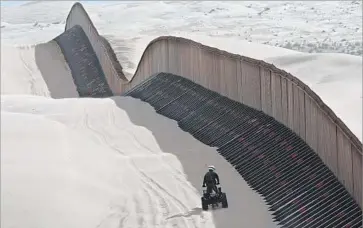  ?? Don Bartletti Los Angeles Times ?? A BORDER AGENT patrols the Imperial Sand Dunes in southeaste­rn California in 2009. The Trump administra­tion has suggested funding a wall along the U.S.-Mexico border, in part, with revenue from an import tax.