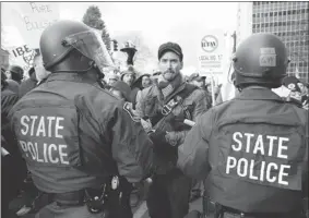  ?? BILL PUGLIANO/ GETTY IMAGES ?? Protesters at the Michigan State Capitol were unable to deter the Republican House of Representa­tives who passed right-to-work legislatio­n Tuesday in Lansing, Mich.