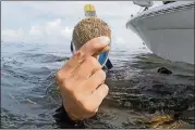  ??  ?? Kaley Taylor holds up a scallop she found in Homosassa Bay.