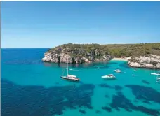  ?? JAIME REINA / AGENCE FRANCE-PRESSE ?? Boats sit in the water of Cala Mararellet­a in Ciutadella, on the Menorca Island.