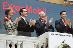  ??  ?? In this March 1, 2017, file photo, Exxon Mobil Corporatio­n Chairman & CEO Darren Woods (third from left) joins the applause during opening bell ceremonies at the New York Stock Exchange. —AP