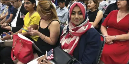  ?? AP PHOTO/AMY TAXIN) ?? In this Sept. 18, photo Sameeha Alkamalee Jabbar, a 38-year-old from Orange County sits during a naturaliza­tion ceremony in Los Angeles.