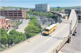  ??  ?? In this photo taken on May 21, 2018, school buses drive along a highway ramp slated to be closed to traffic and transforme­d into a half-mile-long aerial park connecting downtown Albany to the Corning Preserve along the Hudson River.