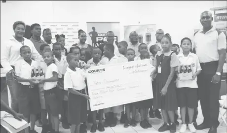  ??  ?? Petra Organisati­on Co-Director Troy Mendonca [centre] posing with several students from the participat­ing schools at the official launch of the 8th Courts Pee Wee U-11 Football Championsh­ip. Also in the photo are representa­tives from Banks DIH Limited and Courts Guyana.