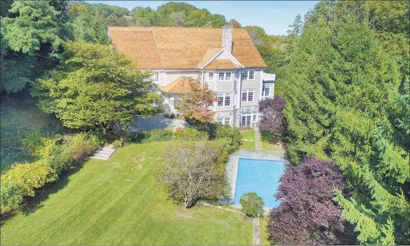  ?? Contribute­d photos ?? The fenced backyard is rendered private by mature trees, deer-resistant plantings, and terraced retaining walls. The current owners added the in-ground pool to the 1.62-acre lot.