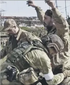  ?? ?? 0 Clockwise from main: An Azov Special Forces Regiment serviceman, injured during fighting; Russian servicemen frisk Ukrainian servicemen as they are being evacuated from Mariupol; Scottish nurse David Anderson