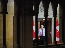  ?? CP PHOTO SEAN KILPATRICK ?? Prime Minister Justin Trudeau makes his way from his office to take part in a year end interview with The Canadian Press on Parliament Hill in Ottawa on Friday.