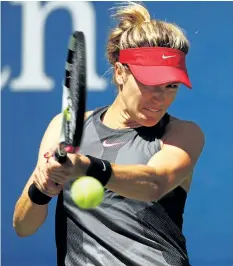  ?? CLIVE BRUNSKILL/GETTY IMAGES ?? Eugenie Bouchard returns a shot to Evgeniya Rodina during her 7-6 (2), 6-1 loss to the Russian on Wednesday, at the U.S. Open, in New York.