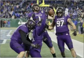  ?? MARK HUMPHREY — THE ASSOCIATED PRESS ?? Northweste­rn safety Kyle Queiro (21) celebrates with teammates after running back an intercepti­on 26yards for a touchdown against Kentucky in the second half of the Music City Bowl NCAA college football game Friday in Nashville, Tenn. Northweste­rn won...