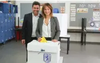  ?? (Marc Israel Sellem/The Jerusalem Post) ?? OFER BERKOVITCH and his wife, Dina, deposit their votes yesterday.