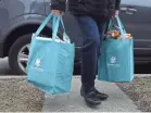  ?? USA TODAY ?? Volunteers deliver meals to the homes of quarantine­d students who attend a school for children with significan­t disabiliti­es in Chicago.