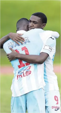  ??  ?? St George’s College Damani Harris (right) embraces teammate Chantomoi Taylor during the ISSA/Digicel Manning Cup secondroun­d match earlier this season. Both players scored in their team’s 2-1 victory over Jamaica College to advance to the 2018 ISSA/Digicel Manning Cup final.