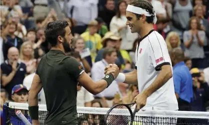  ?? Photograph: Ray Stubblebin­e/ EPA ?? Roger Federer (right) is congraulat­ed bu Damir Dzumhur after their second-round match at the US Open.