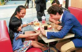  ??  ?? Canadian Prime Minister Justin Trudeau high-fives a youngguest.