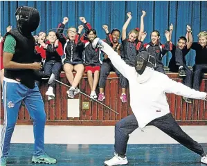  ?? / FREDLIN ADRIAAN/WEEKEND POST. ?? Olympic fencer Sello Maduma takes a hit from Ross Henderson of St George’s Primary School.