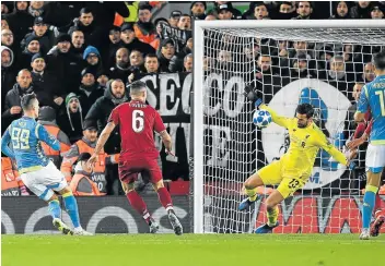  ?? Picture: AFP/PAUL ELLIS ?? UP FOR THE CHALLENGE: Liverpool gloveman Alisson Becker saves a shot from Napoli striker Arkadiusz Milik during the Uefa Champions League match at Anfield stadium in Liverpool on Tuesday.