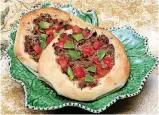 ??  ?? Sfeeha or meat pies are placed on a dish at St. Elijah Orthodox Christian Church which will host its annual Food Festival on Nov. 2 and Nov. 3.