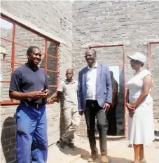  ??  ?? Tshino Village project manager, Mr Davies Takaendesa, explains to the Zanu-PF Politiburo member who is also the Tsholotsho North Member of Parliament, Professor Jonathan Moyo (centre) and Tsholotsho District Administra­tor Gladys Zizhou (centre) during...