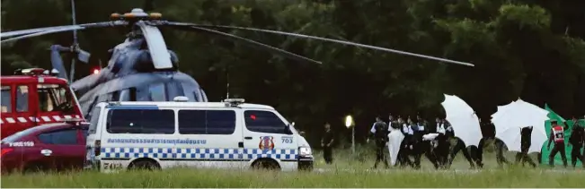  ?? Vincent Thian/Associated Press ?? Equipe de emergência que trabalhou no resgate dos jovens presos em caverna na Tailândia