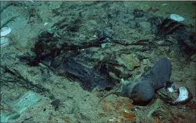  ?? INSTITUTE FOR EXPLORATIO­N, CENTER FOR ARCHAEOLOG­ICAL OCEANOGRAP­HY ?? The remains of a coat and boots in the mud on the sea bed near the Titanic’s stern.