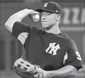  ?? NATHAN DENETTE/THE CANADIAN PRESS/AP PHOTO ?? The Yankees’ Aaron Judge throws the ball during Wednesday’s workout in Toronto. The Yankees open their season today against Toronto.