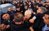  ?? AP/DHA ?? A protester punches Turkish opposition leader Kemal Kilicdarog­lu during a funeral Sunday outside Ankara.