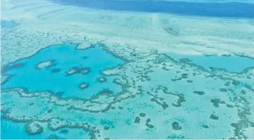  ??  ?? This file photo shows an aerial view of the Great Barrier Reef off the coast of the Whitsunday Islands, along the central coast of Queensland. — AFP photo