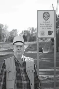  ?? Staff photo by Evan Lewis ?? Jim Smith, former De Queen, Ark., police chief, is photograph­ed in front of one of the four signs the city recently erected honoring the four city officers who died in an auto accident July 5, 1984.